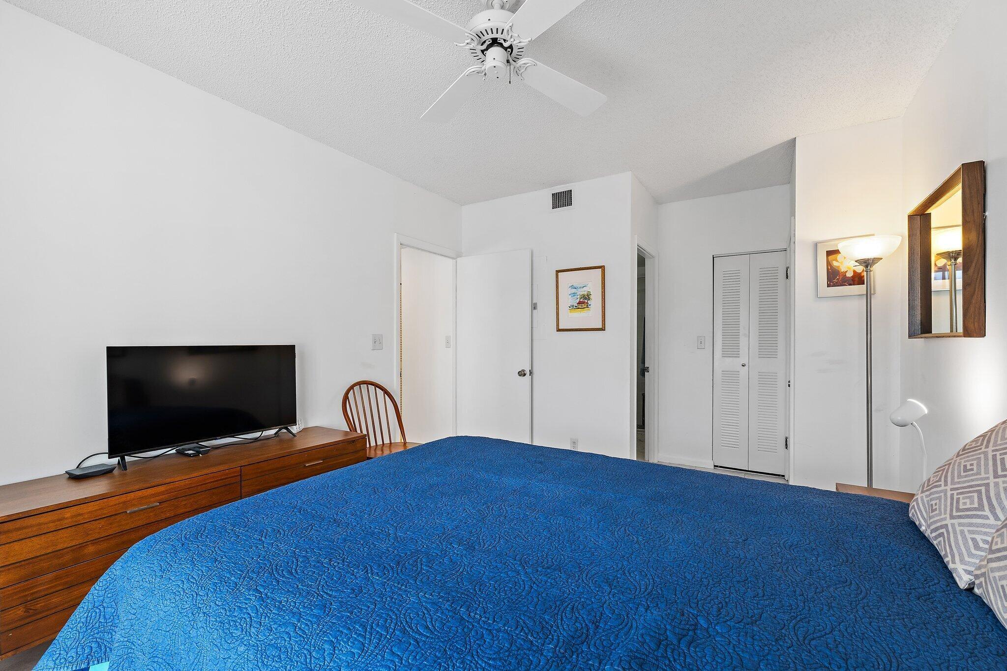 353 Highway 1, Unit C7 Jupiter, FL 33477 - Photo 23 of 45 a bedroom with a bed and a flat screen tv