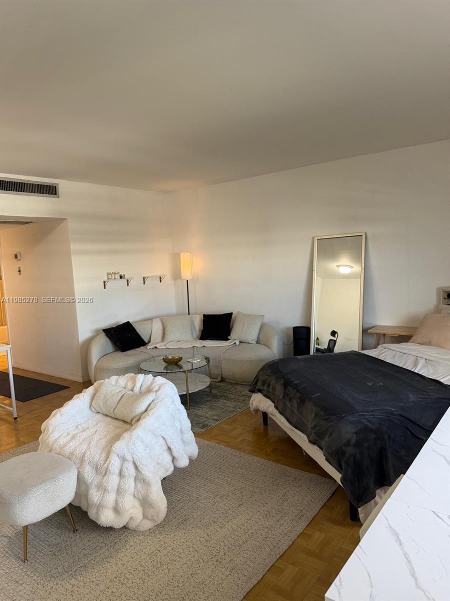 a bedroom with a bed and a mirror