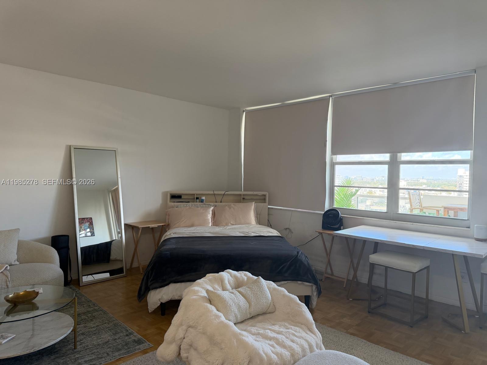 100 Lincoln Road, Unit 1512 Miami Beach, FL 33139 - Photo 2 of 21 a bedroom with a bed and a large window