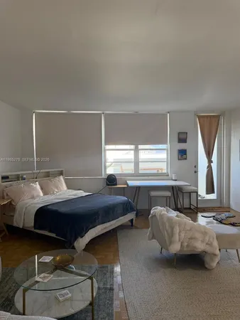 a bedroom with bed and window