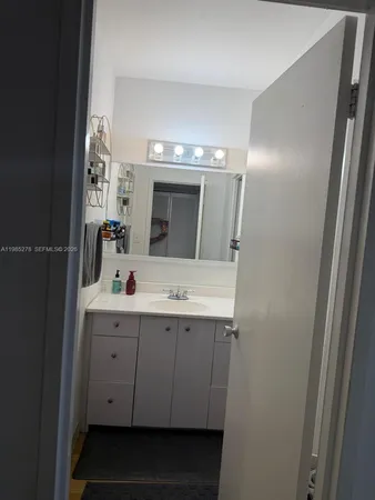a bathroom with a double vanity sink and mirror