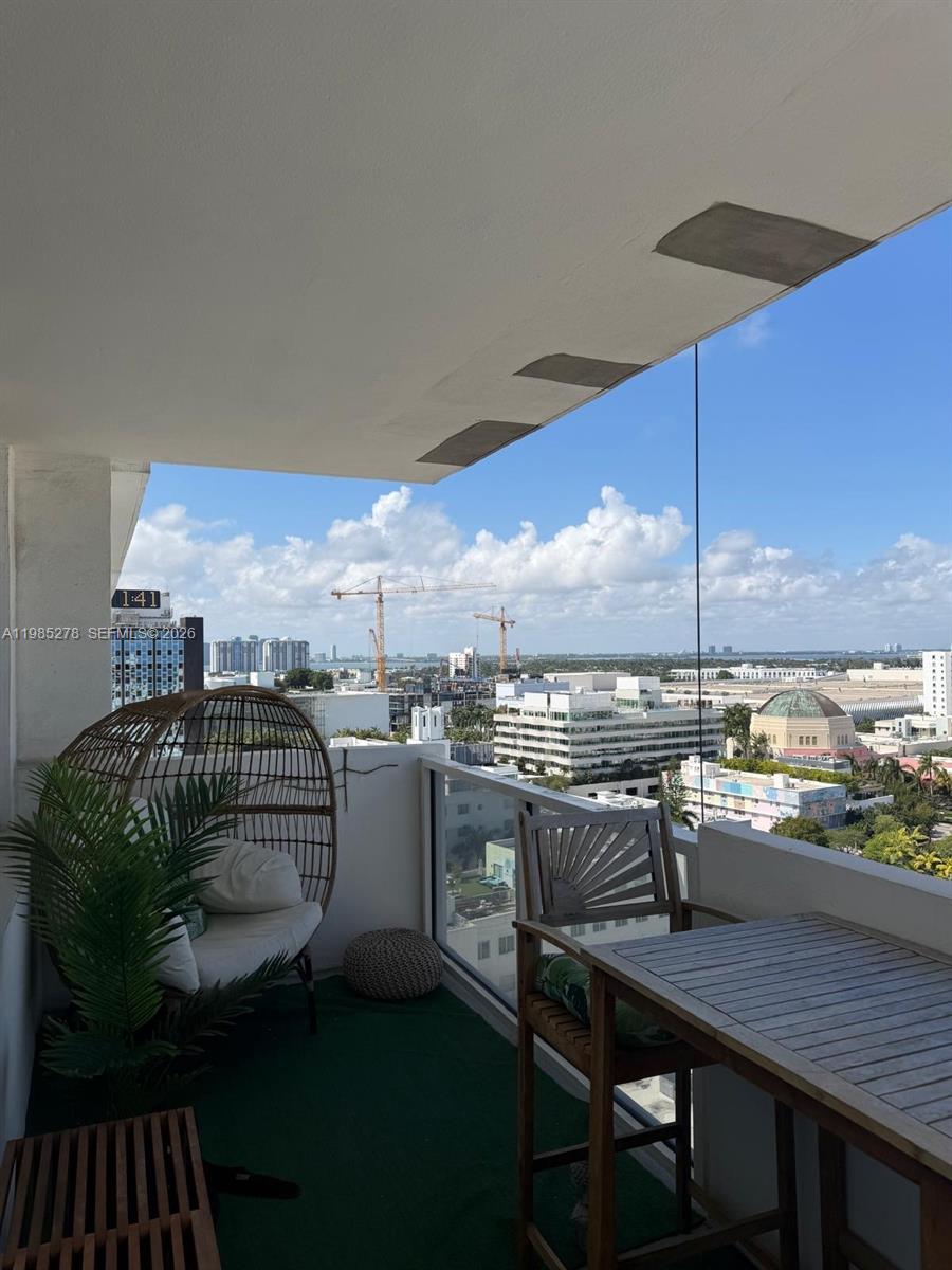 100 Lincoln Road, Unit 1512 Miami Beach, FL 33139 - Photo 8 of 21 a kitchen with a table chairs and a stove
