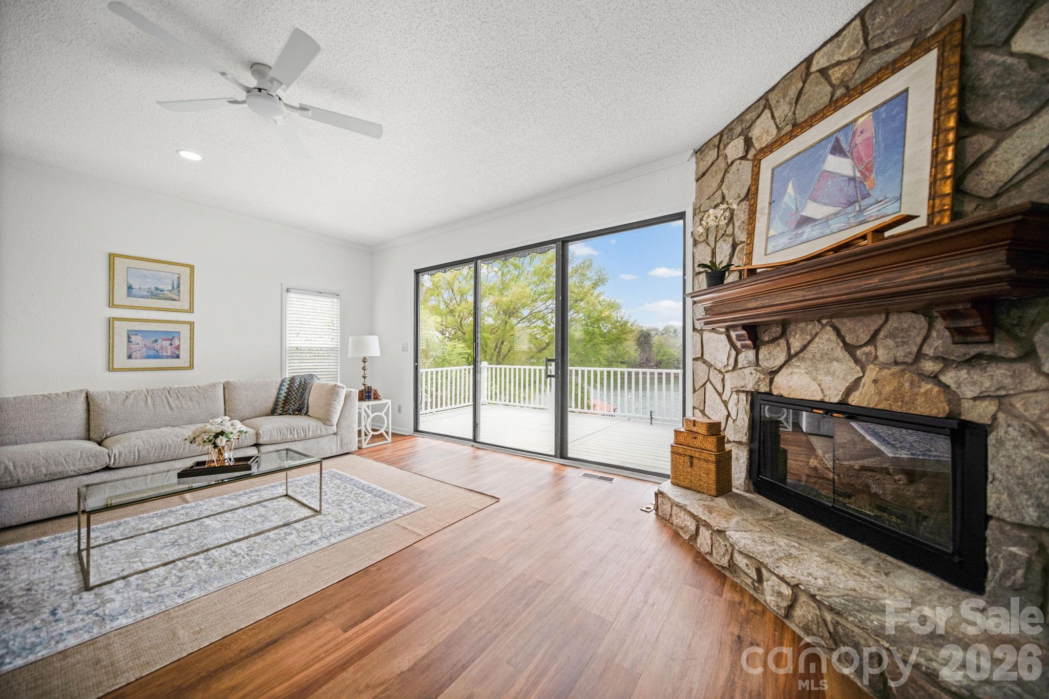 529 Catspaw Road Statesville, NC 28677 - Photo 6 of 48 a living room with furniture a fireplace and a flat screen tv