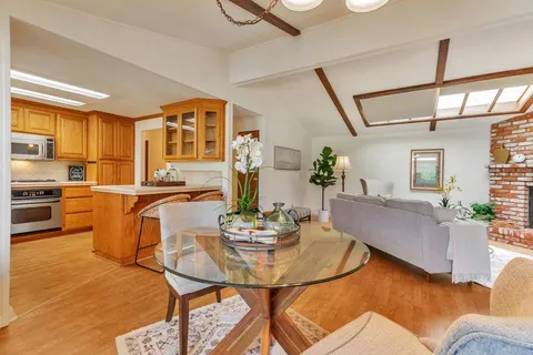 a living room with furniture and kitchen view