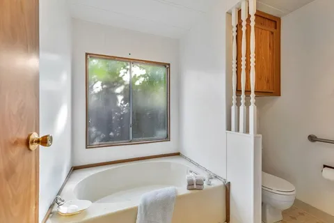 a white bath tub sitting next to a toilet