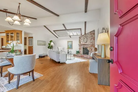 a living room with furniture a fireplace and wooden floor