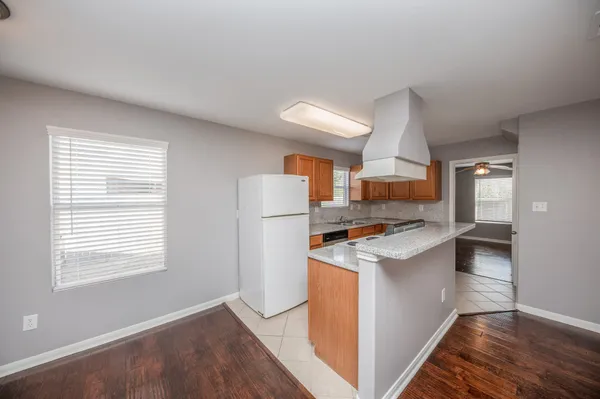 a kitchen with a stove and a refrigerator