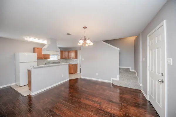 a view of a kitchen with wooden floor and a kitchen