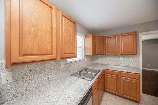 a kitchen with stainless steel appliances granite countertop a sink and cabinets