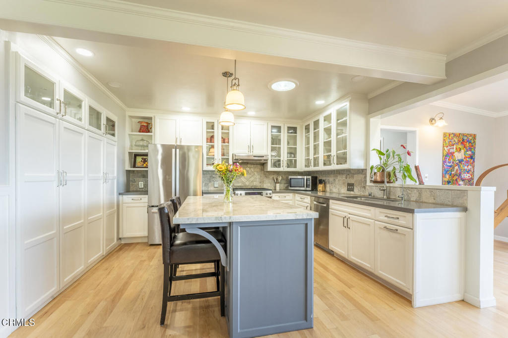 32751 Navarro Ridge Road Albion, CA 95410 - Photo 17 of 57 a kitchen with stainless steel appliances a dining table chairs sink and cabinets