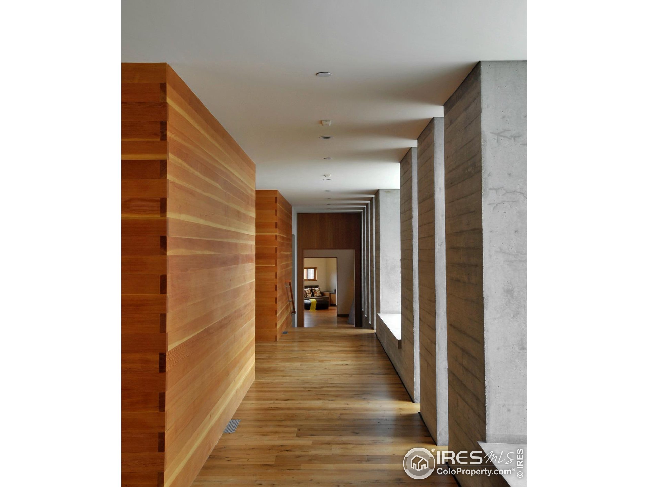1355 South Cherryvale Road Boulder, CO 80303 - Photo 16 of 40 a view of a hallway with wooden floor and a bathroom