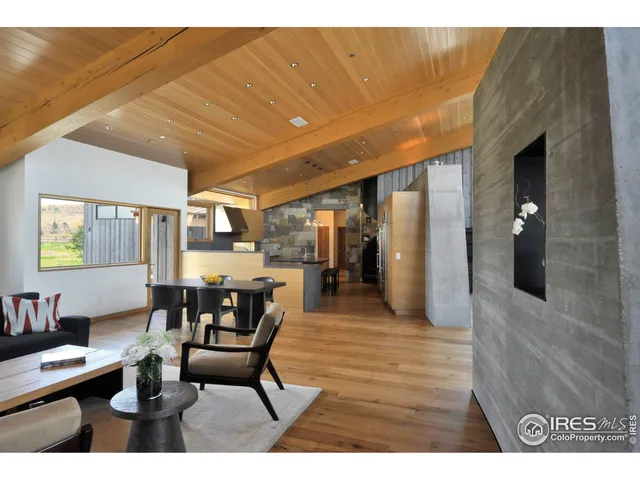 a dining room with furniture and wooden floor