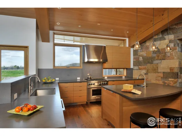 a kitchen with stainless steel appliances granite countertop a sink dishwasher stove and cabinets