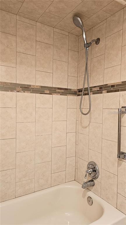 4330 Tahitian Gardens Circle, Unit C Holiday, FL 34691 - Photo 12 of 20 a bathroom with a sink and a shower