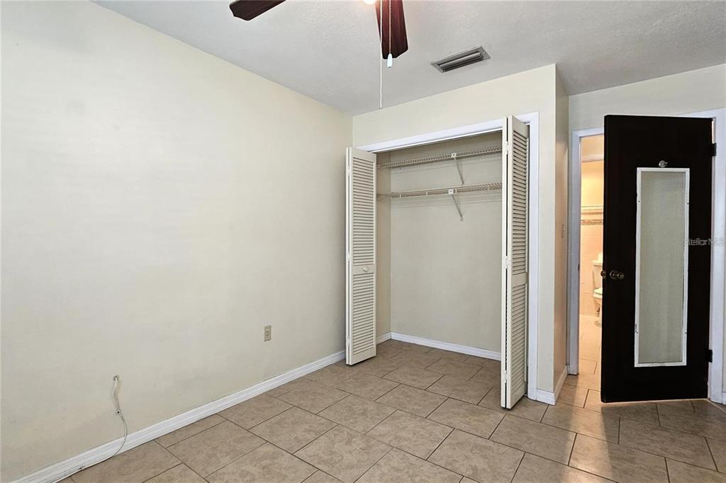 4330 Tahitian Gardens Circle, Unit C Holiday, FL 34691 - Photo 16 of 20 an empty room with closet and a chandelier fan