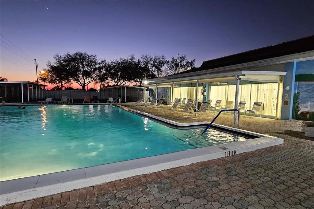 4330 Tahitian Gardens Circle, Unit C Holiday, FL 34691 - Photo 18 of 20 a view of a swimming pool with a patio