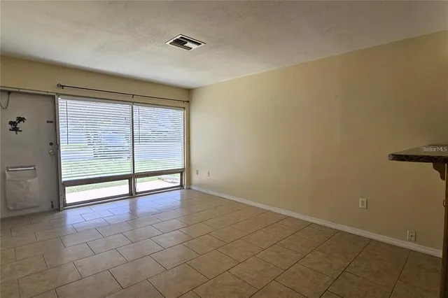 a view of an empty room with glass door
