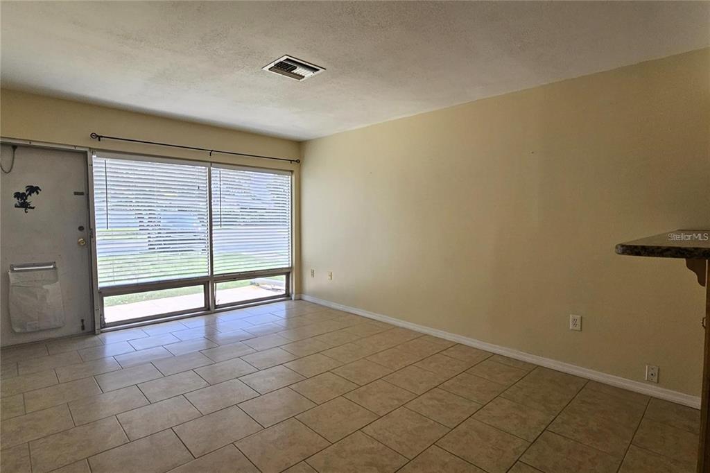 4330 Tahitian Gardens Circle, Unit C Holiday, FL 34691 - Photo 5 of 20 a view of an empty room with glass door