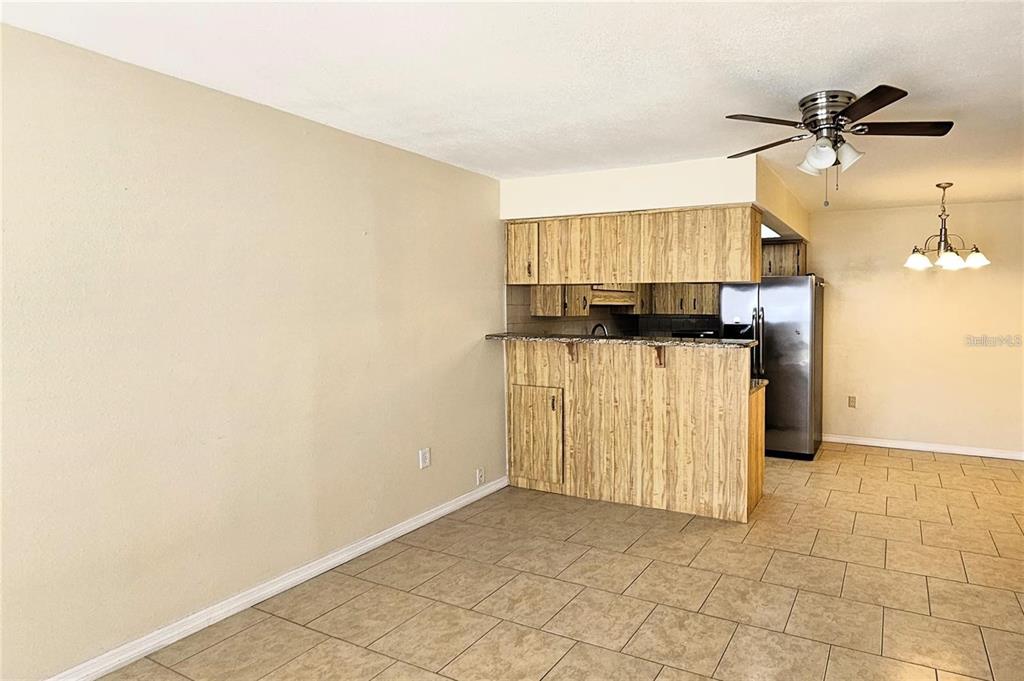 4330 Tahitian Gardens Circle, Unit C Holiday, FL 34691 - Photo 6 of 20 an empty room with windows and fan