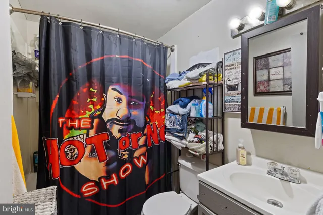 a bathroom with a sink mirror and vanity