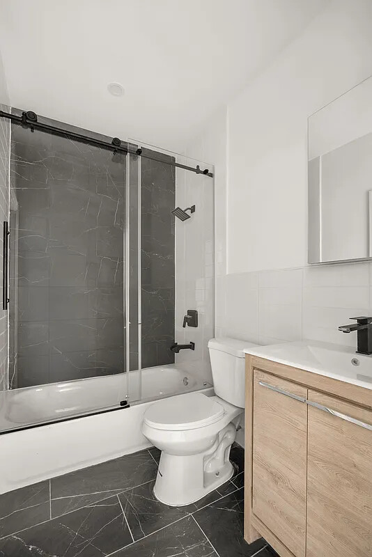 9 Kane Place Brooklyn, NY 11233 - Photo 10 of 18 a bathroom with a toilet sink and shower