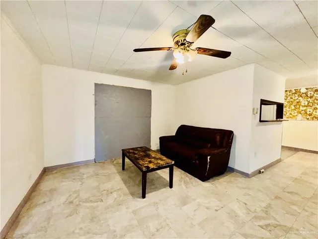 a living room with couches and wooden floor