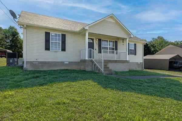 a front view of house with yard and green space