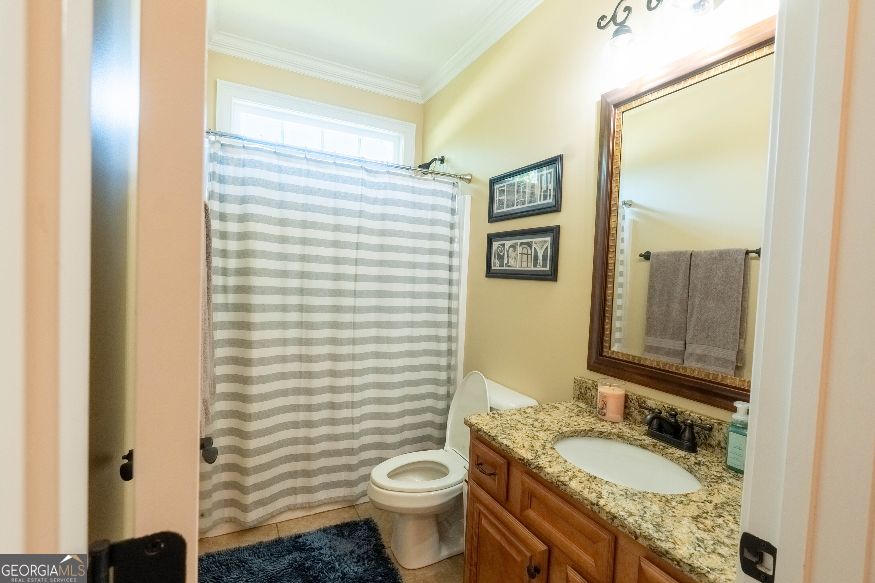 501 Old Bridge Road Warner Robins, GA 31088 - Photo 24 of 54 a bathroom with a granite countertop toilet a sink and a mirror