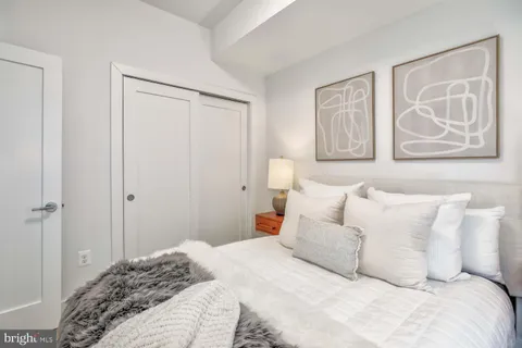 a bedroom with a bed and wall painting