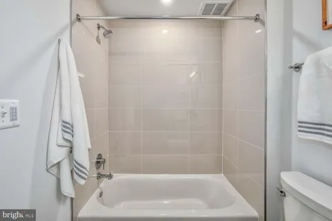 a bathroom with a shower and a toilet