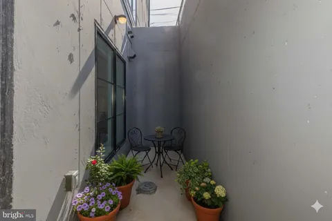 a vase with flowers sitting on a floor