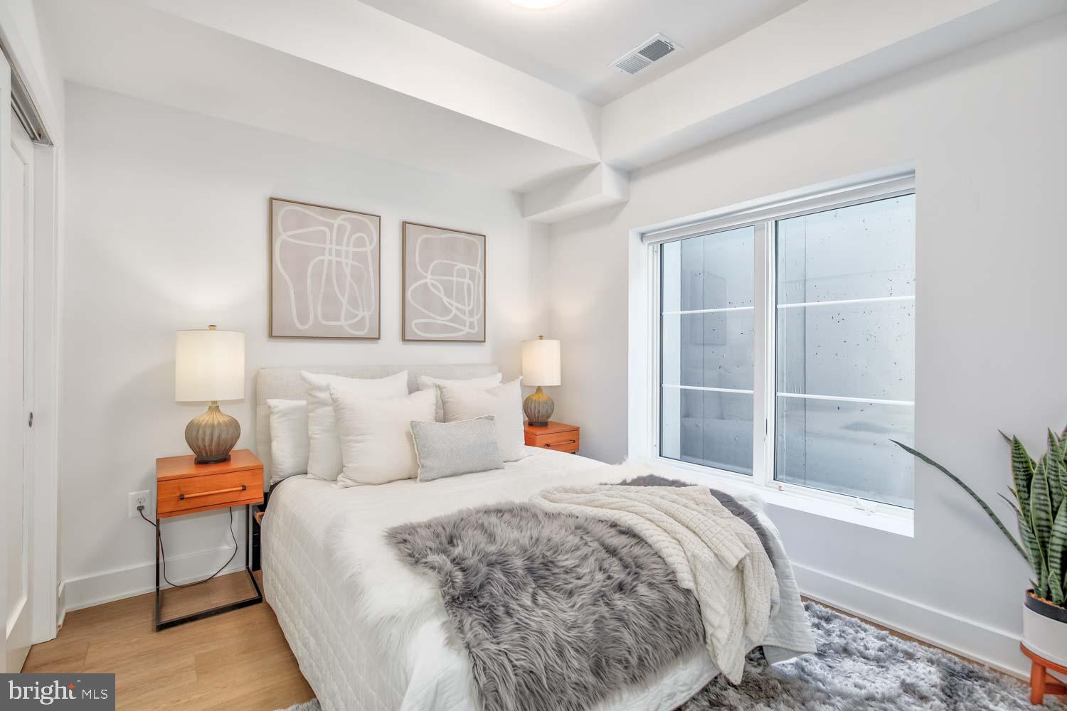2310 4th Street Northeast, Unit FIVE Washington, DC 20002 - Photo 9 of 19 a bedroom with a bed and a window
