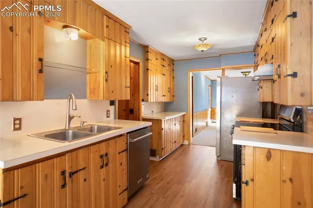 a kitchen with stainless steel appliances a sink and a refrigerator