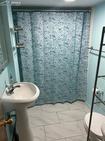 a bathroom with a sink a mirror and a shower