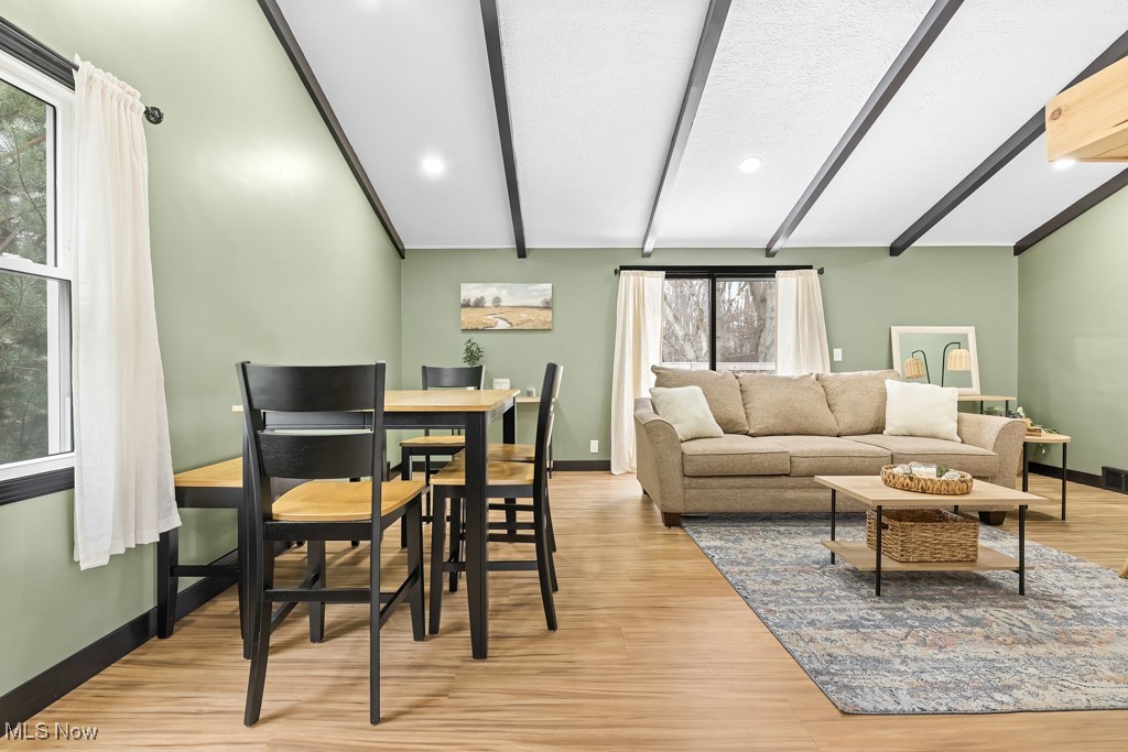 4551 17th Street Northwest Canton, OH 44708 - Photo 12 of 39 Living area with lofted ceiling with beams, light wood-style floors, visible vents, and baseboards