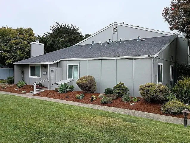 a backyard of a house with table and chairs