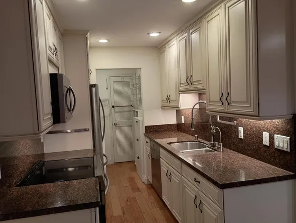 a kitchen with a sink stove and refrigerator