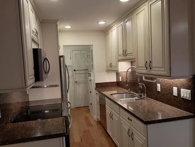 a kitchen with a sink stove and refrigerator
