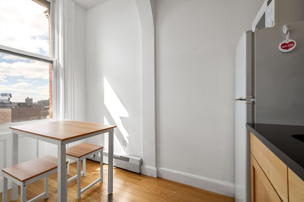 483 Beacon Street, Unit PH4 Boston, MA 02115 - Photo 11 of 18 a view of a hallway with furniture and wooden floor