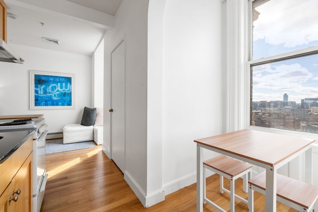 483 Beacon Street, Unit PH4 Boston, MA 02115 - Photo 12 of 18 a living room with stainless steel appliances furniture and a large window