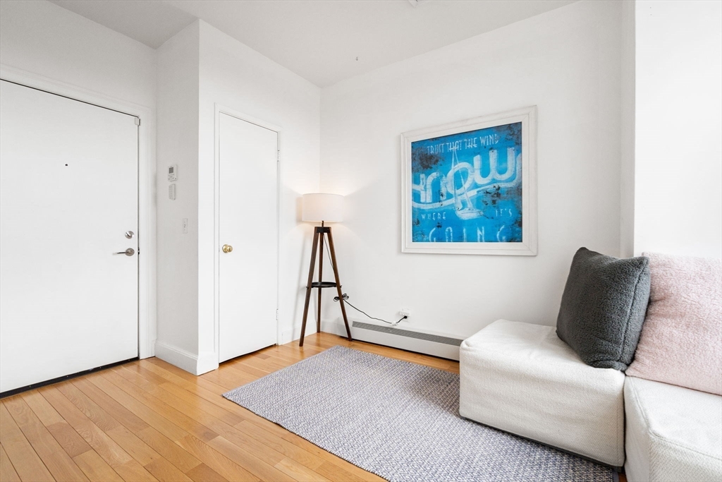 483 Beacon Street, Unit PH4 Boston, MA 02115 - Photo 14 of 18 a living room with furniture and a wooden floor