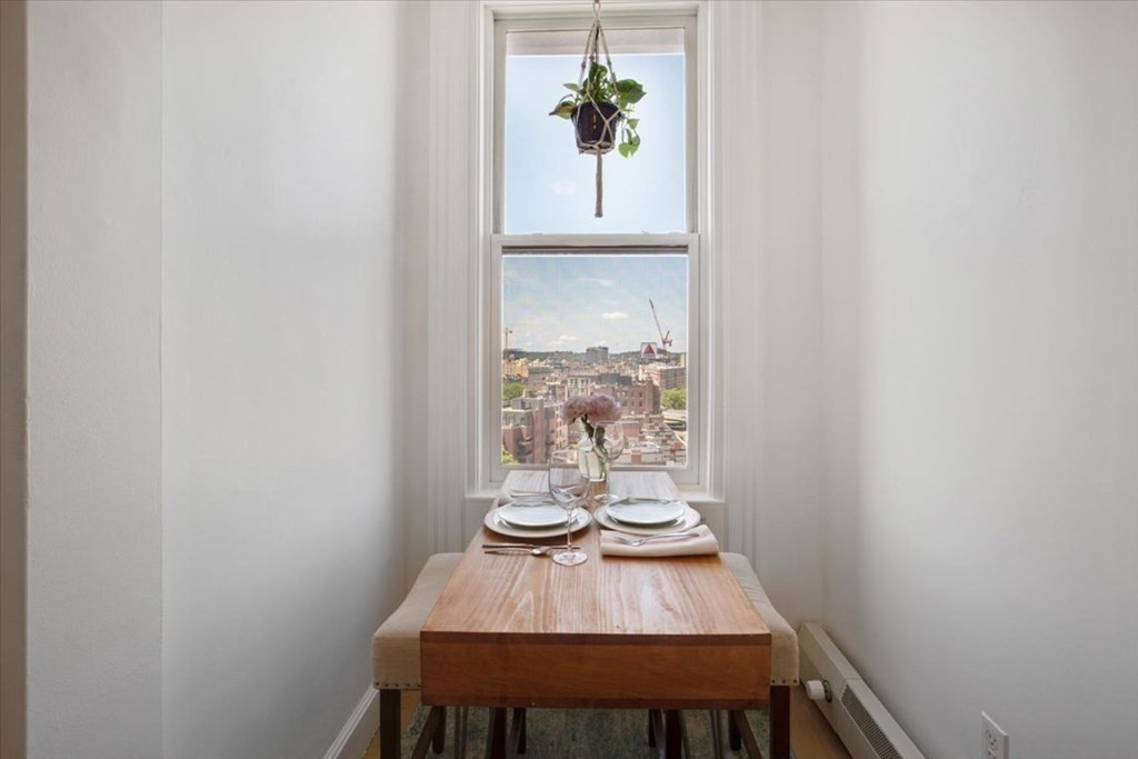 483 Beacon Street, Unit PH4 Boston, MA 02115 - Photo 3 of 18 a view of a dining room with furniture and window