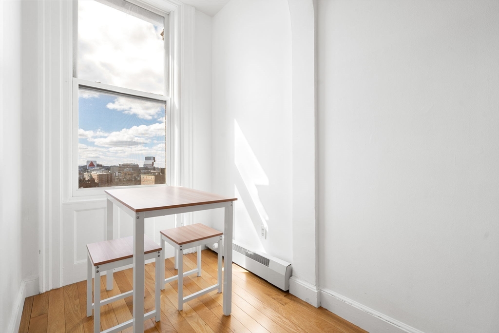 483 Beacon Street, Unit PH4 Boston, MA 02115 - Photo 4 of 18 a dining room with wooden floor and a window