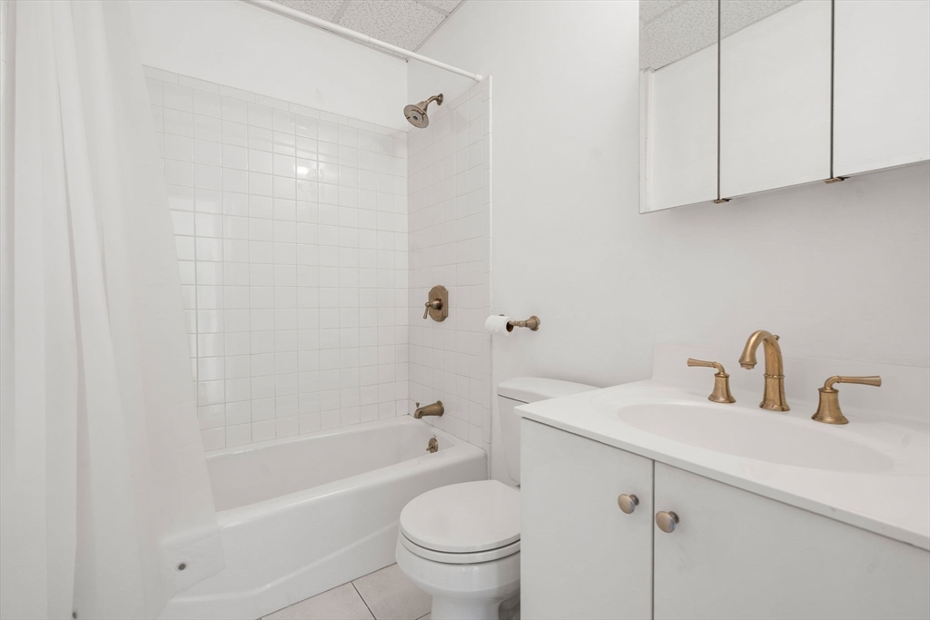 483 Beacon Street, Unit PH4 Boston, MA 02115 - Photo 5 of 18 a bathroom with a sink a toilet and shower