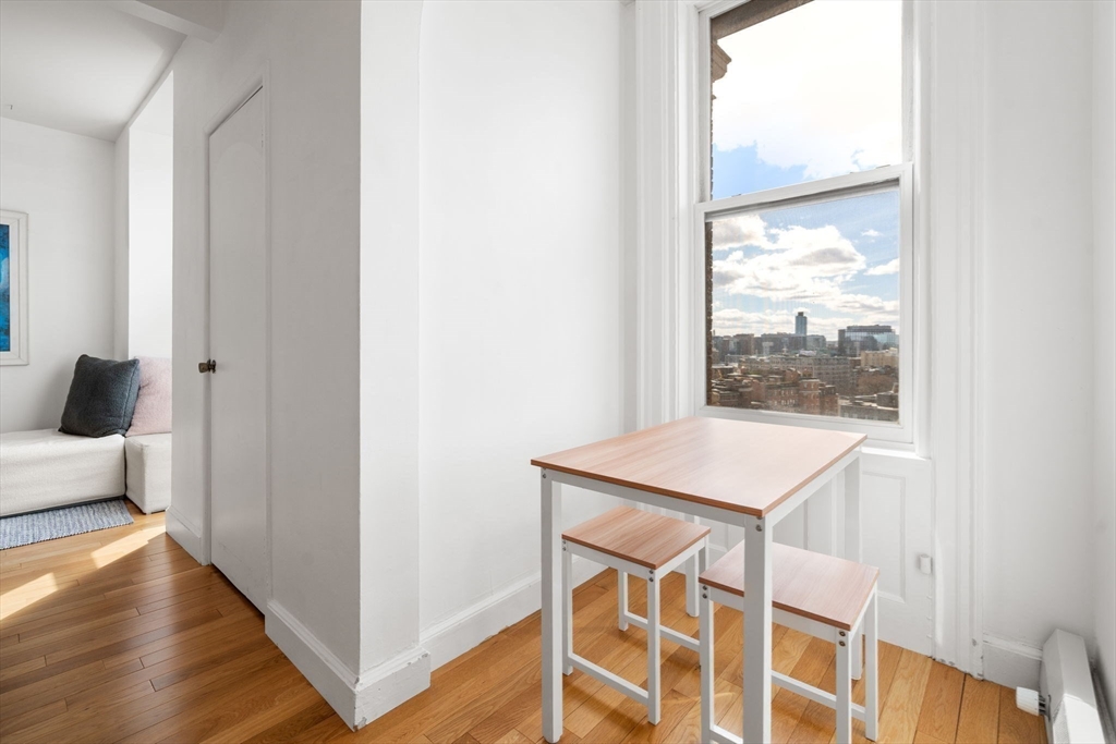 483 Beacon Street, Unit PH4 Boston, MA 02115 - Photo 10 of 18 a view of an empty room with wooden floor and a window