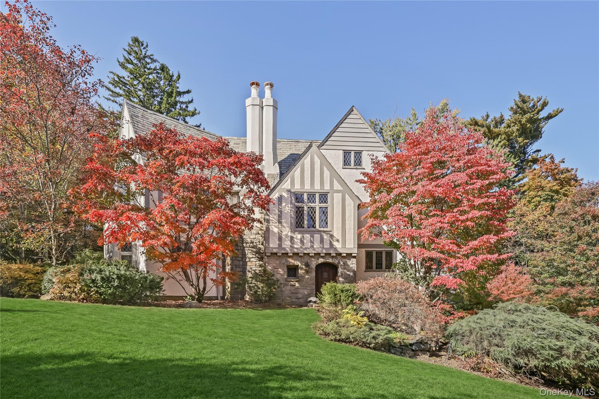 a front view of a house with a garden