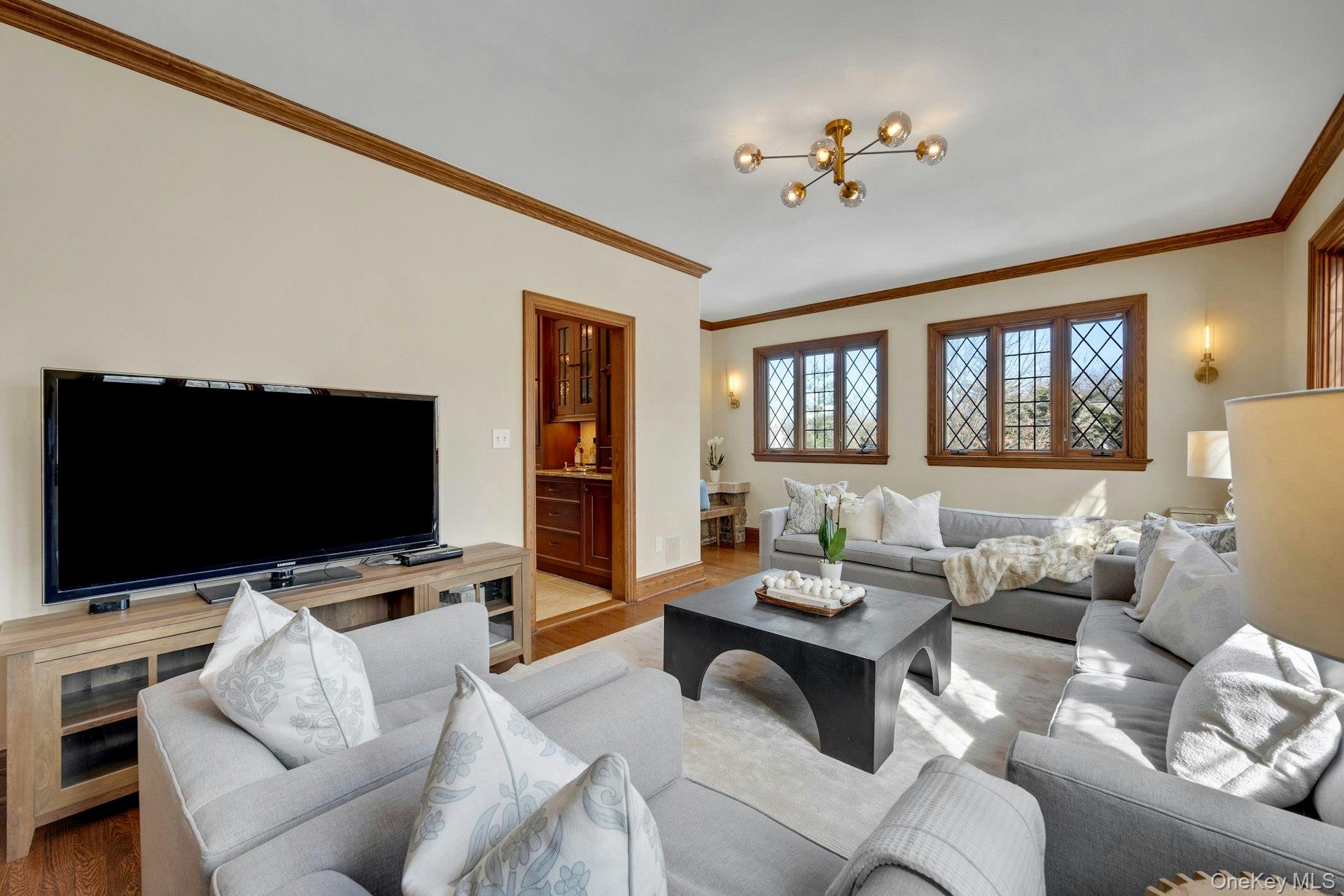 15 Carstensen Road Scarsdale, NY 10583 - Photo 11 of 35 a living room with furniture and a flat screen tv