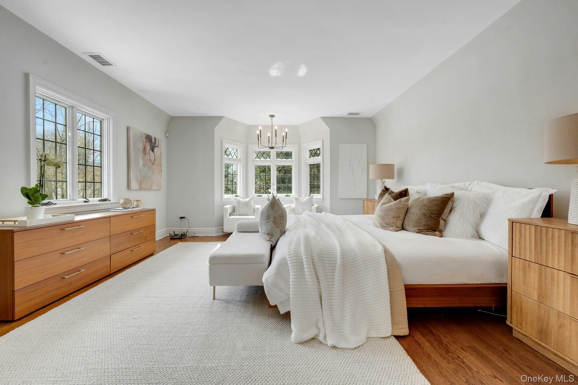15 Carstensen Road Scarsdale, NY 10583 - Photo 14 of 35 a spacious bedroom with a bed and a couch