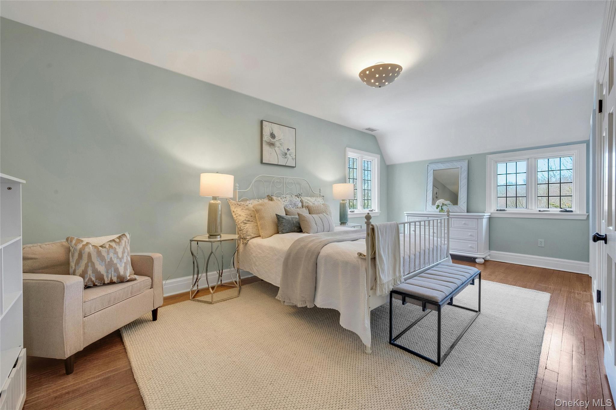 15 Carstensen Road Scarsdale, NY 10583 - Photo 20 of 35 a spacious bedroom with a bed and wooden floor