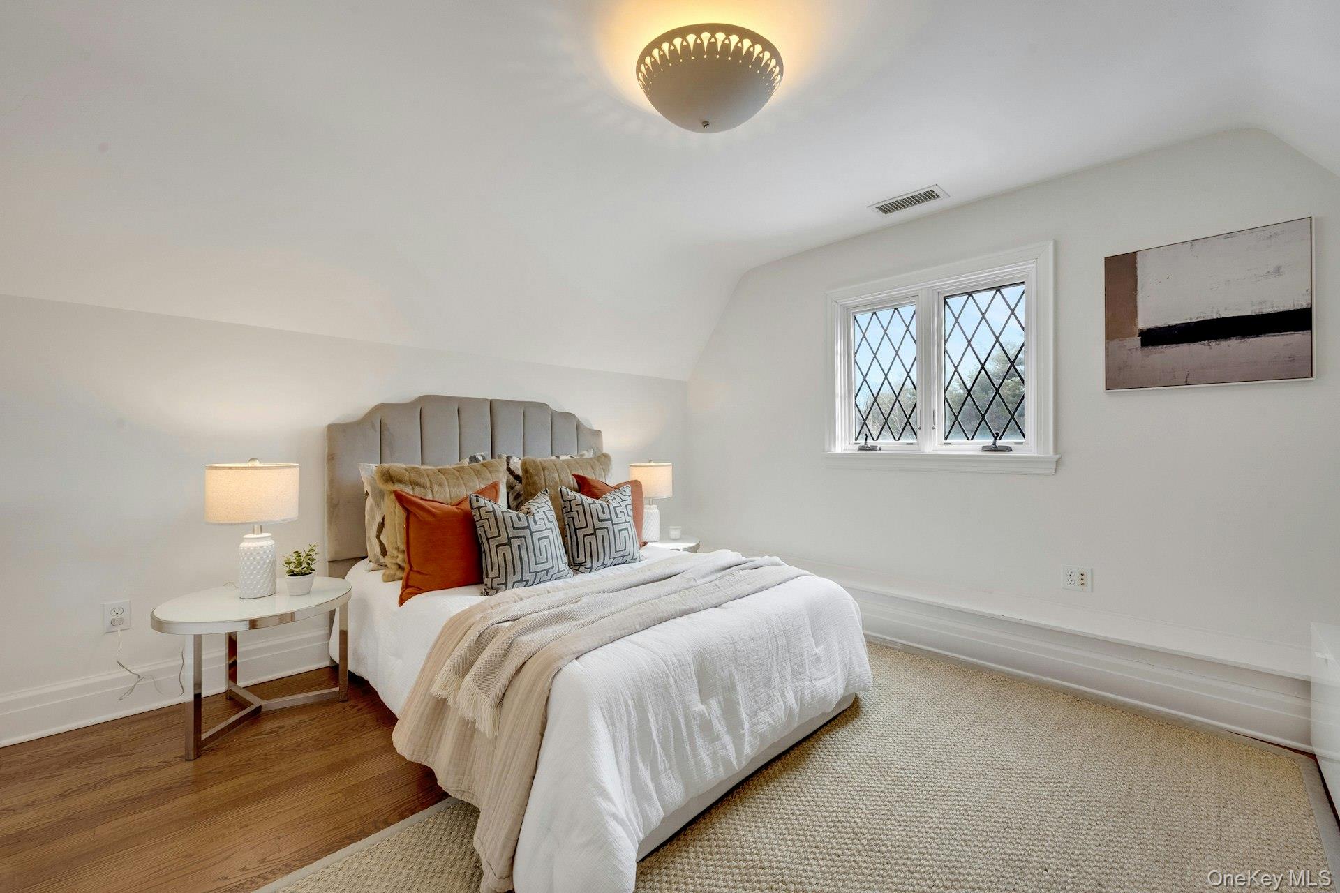 15 Carstensen Road Scarsdale, NY 10583 - Photo 22 of 35 a bedroom with a bed and a chandelier